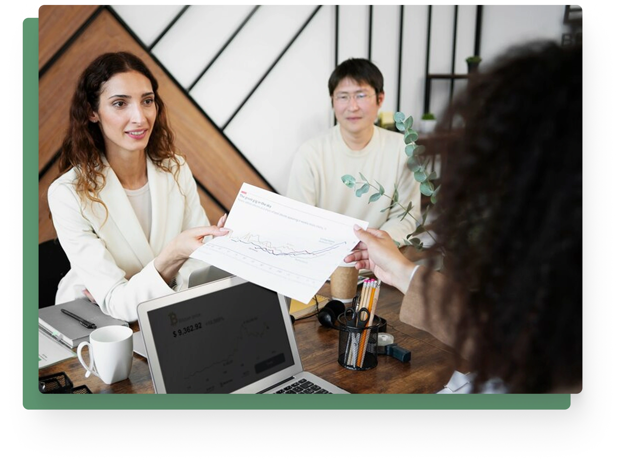 Professional woman sharing a data chart during a team meeting in a modern office